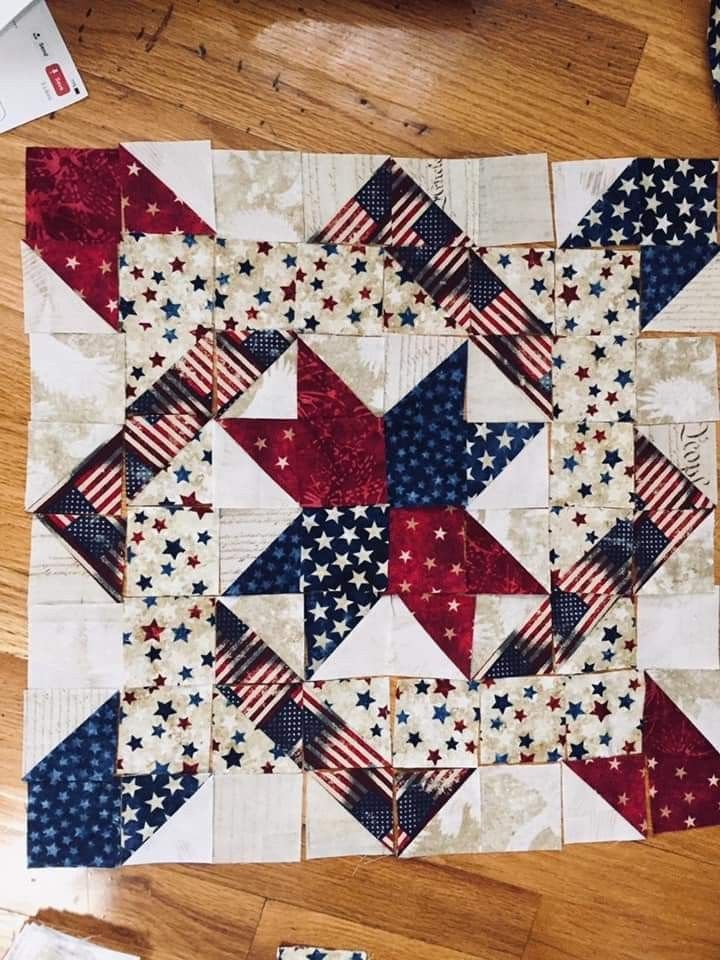 an american flag quilt is laying on the floor