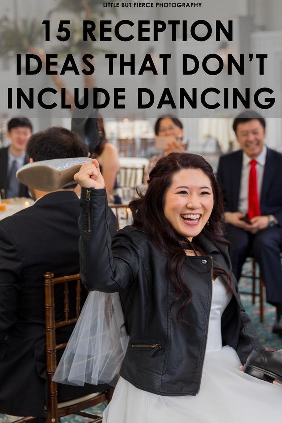 a woman in a white dress and black jacket is dancing with her hands up to the side