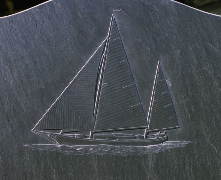 a sailboat carved into the side of a rock