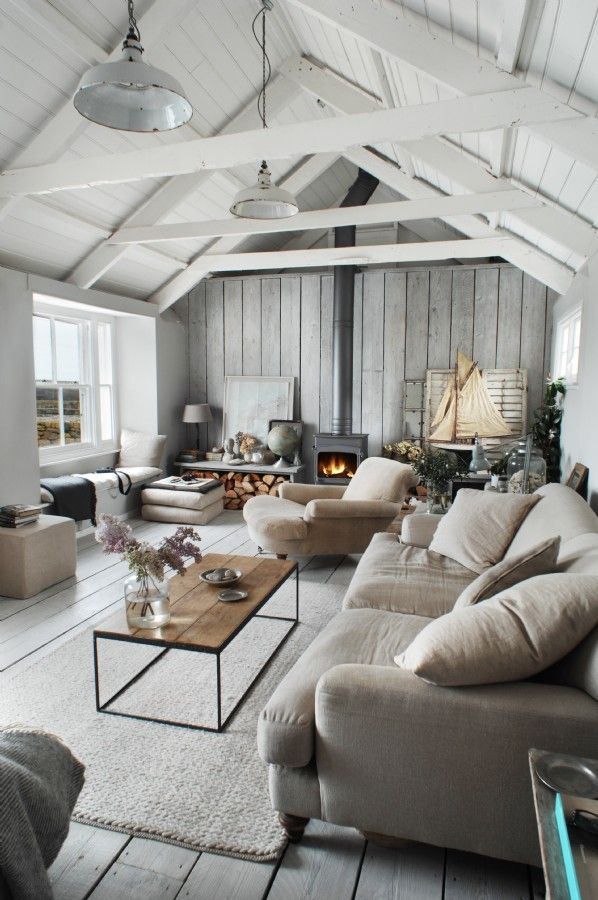 a living room filled with furniture and a fire place in the middle of the room