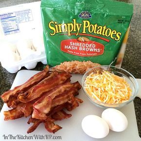 bacon, eggs and shredded hash browns sit on a cutting board next to a bag of potato chips