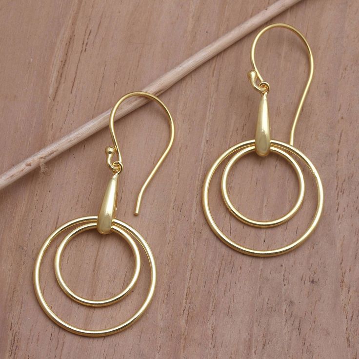 Gleaming gold is timeless in these dangle earrings from Suana Yasa in Bali. The earrings are crafted from brass and plated in 18k gold in a design to wear anywhere. Elegant Gold-plated Cadmium-free Earrings, Elegant Gold Plated Cadmium-free Earrings, Gold Nickel-free Round Linear Earrings, Nickel-free Gold Linear Earrings, Gold Tarnish Resistant Round Linear Earrings, Yellow Gold Drop Earrings Cadmium-free, Modern Gold Nickel-free Earrings, Cadmium-free Yellow Gold Dangle Earrings, Cadmium-free Yellow Gold Drop Earrings