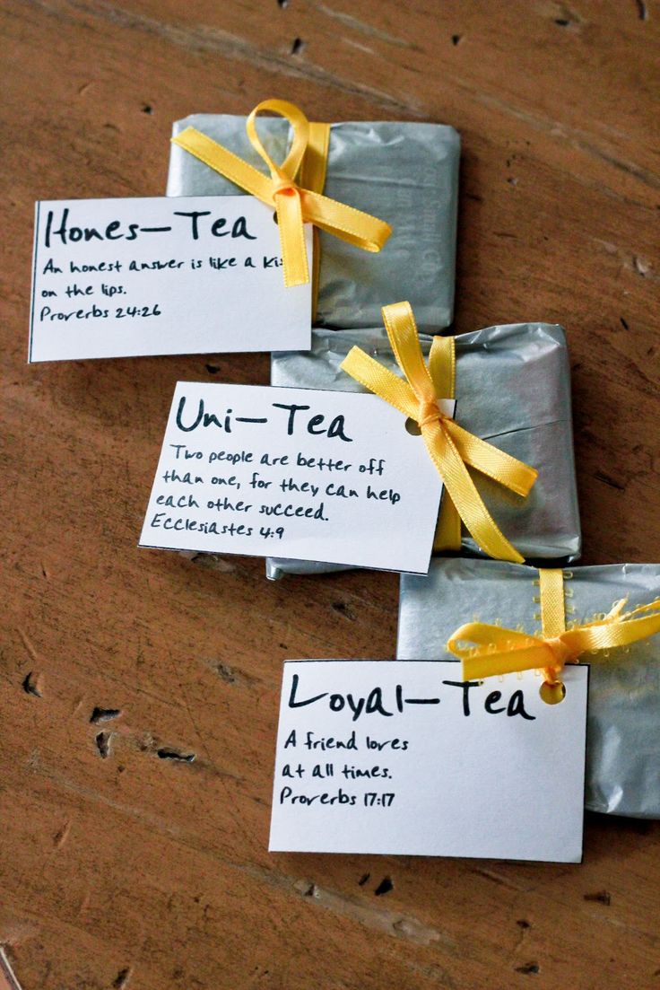 three wrapped tea bags with yellow ribbons tied around them