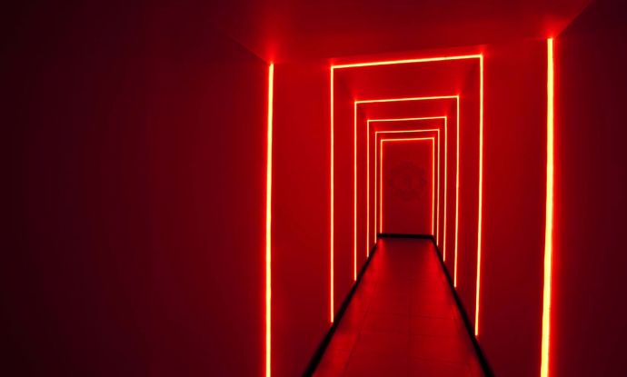 a long hallway with red lights in the middle