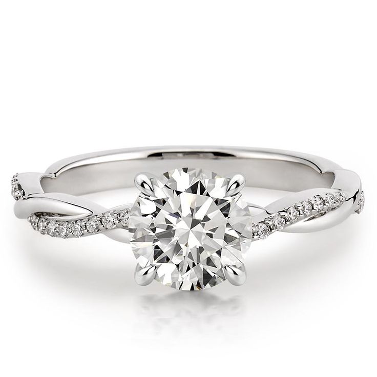 a white gold engagement ring with a twisted band and a round brilliant diamond center stone