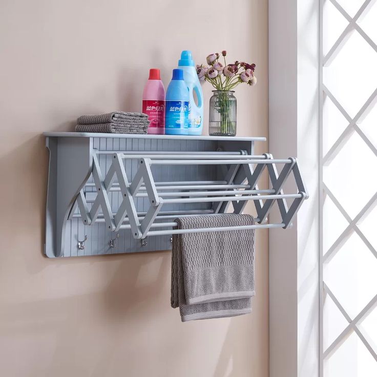 a bathroom shelf with towels and bottles on it