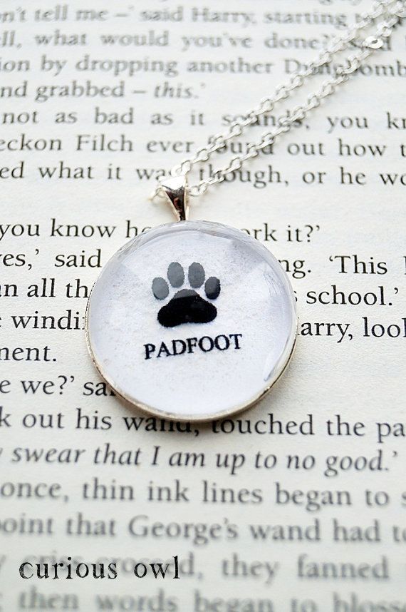 a necklace with a paw print on it and the words padfoot written in black ink