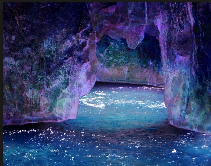 the water is blue and green in this cave like area with rocks on either side