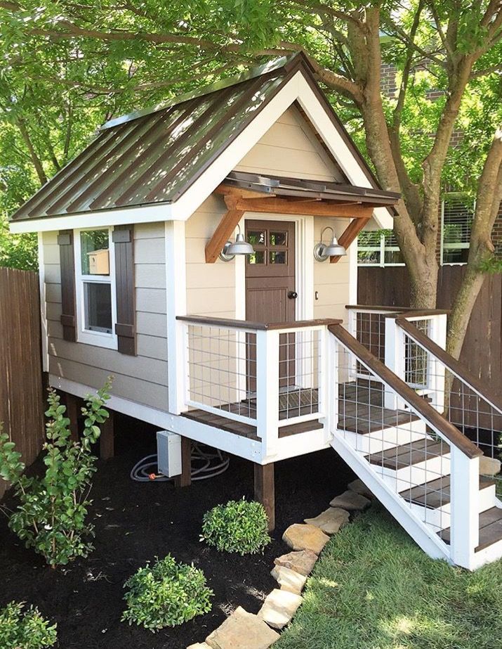 a small house with stairs leading up to it