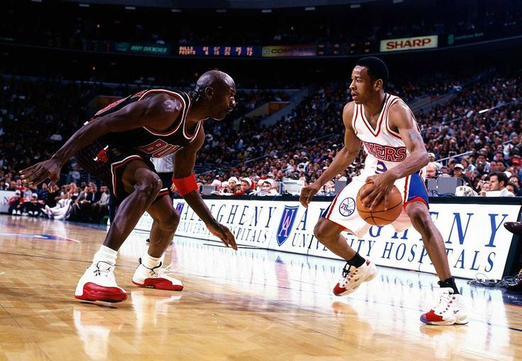 two basketball players are playing on the court