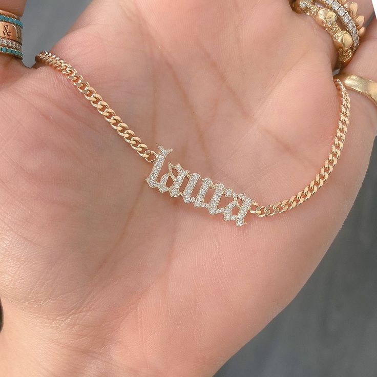 This unique personalized Old English font nameplate cut-out necklace is composed of 14K solid gold and beautifully pavé set with genuine GVs1 quality natural real Diamonds. This pendant is complemented by a durable 14K solid gold adjustable chain or can be purchased as a charm alone without the chain under the "Length" drop-down menu. NOTE: The item will be made in the exact casing of the characters entered. Please be mindful of this detail when providing the customization desired. Name Dimensio Luxury Custom Nameplate Jewelry, Luxury Classic Nameplate Necklace, Luxury Nameplate Jewelry, Custom Name 14k White Gold Jewelry, Custom Name White Gold Nameplate Jewelry, Gold Plated Custom Name Jewelry Nameplate, Luxury Nameplate Necklace With Diamond Accents, White Diamond Nameplate Jewelry, Fine Jewelry Custom Name Necklace In White Gold