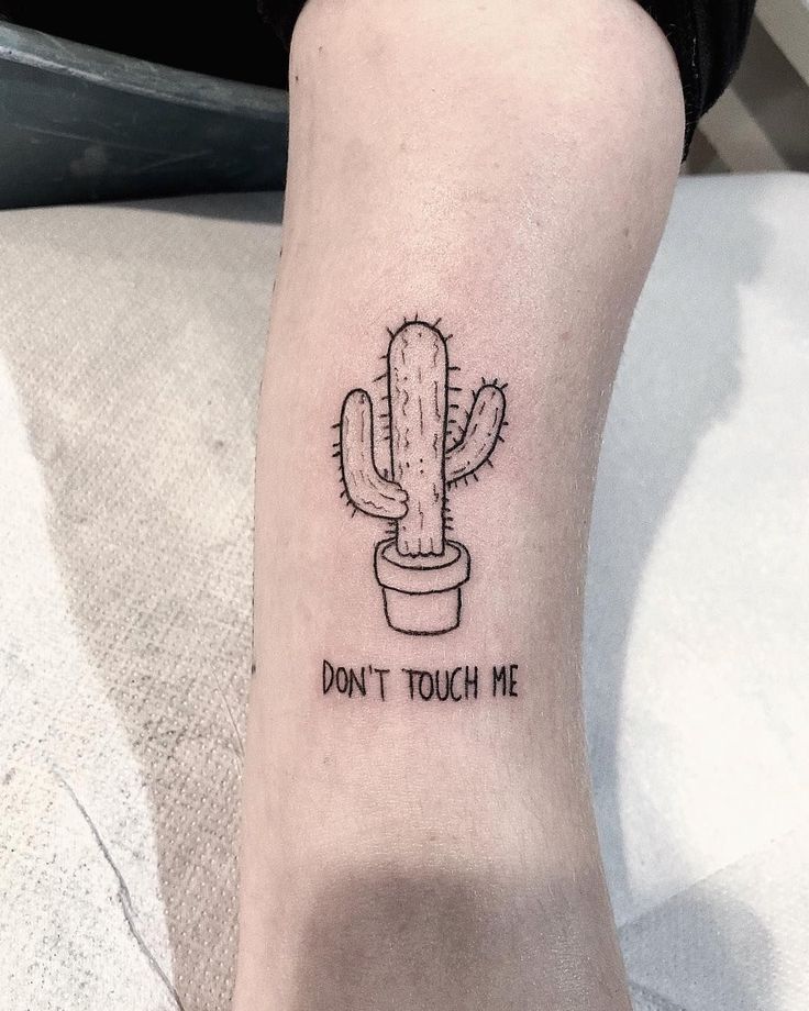 a small cactus tattoo on the ankle that says, don't touch me in black ink