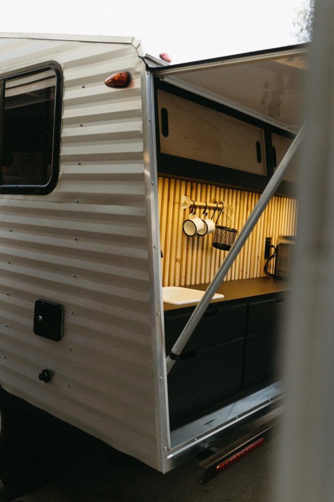 an rv parked in a parking lot with its door open and the interior doors opened