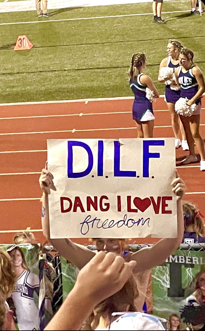 a woman holding a sign that reads dilff dang i love bacon