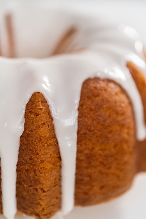 a bundt cake with white icing on a plate