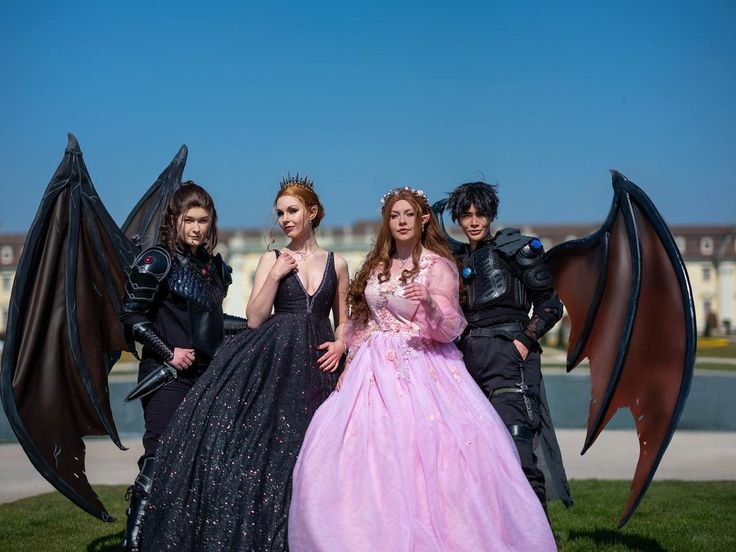 four people dressed in costumes posing for a photo