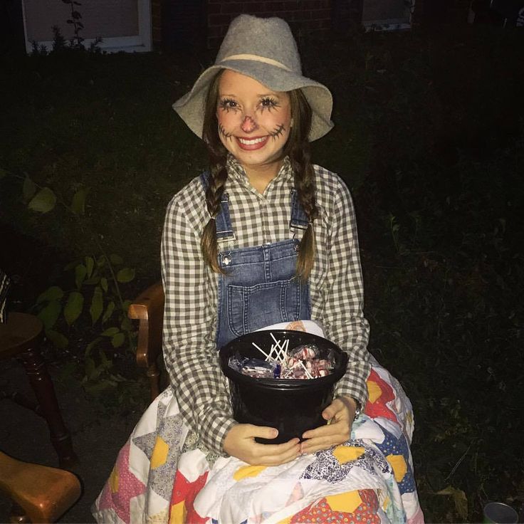 a woman sitting on a chair holding a black bowl in her hands and smiling at the camera