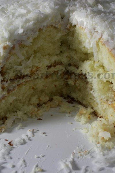 a close up of a cake with white frosting