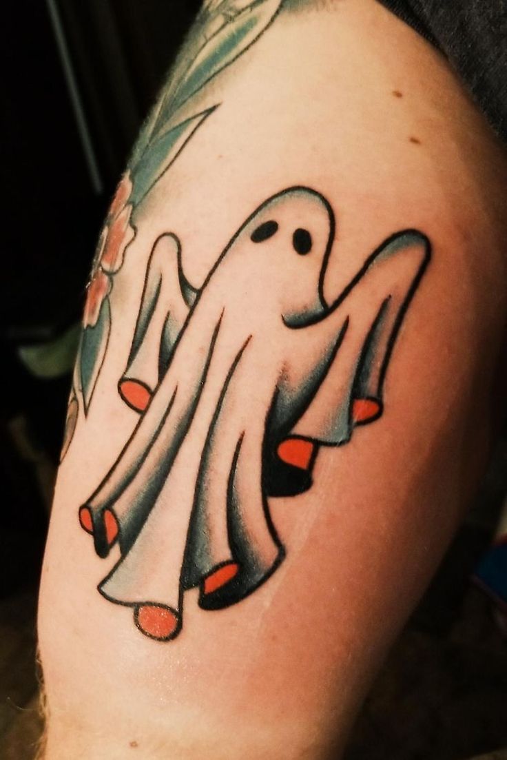 a man with a ghost tattoo on his leg