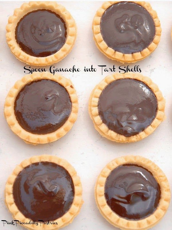 six chocolate tarts with faces on them