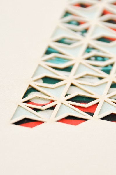 a close up view of some type of geometric pattern on paper with red, green and blue colors