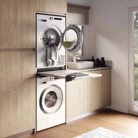 a washer and dryer in a room with wood flooring on the walls