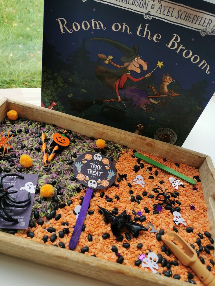 a wooden box filled with halloween decorations and books