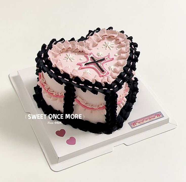 a heart shaped cake sitting on top of a white box with the words sweet once more