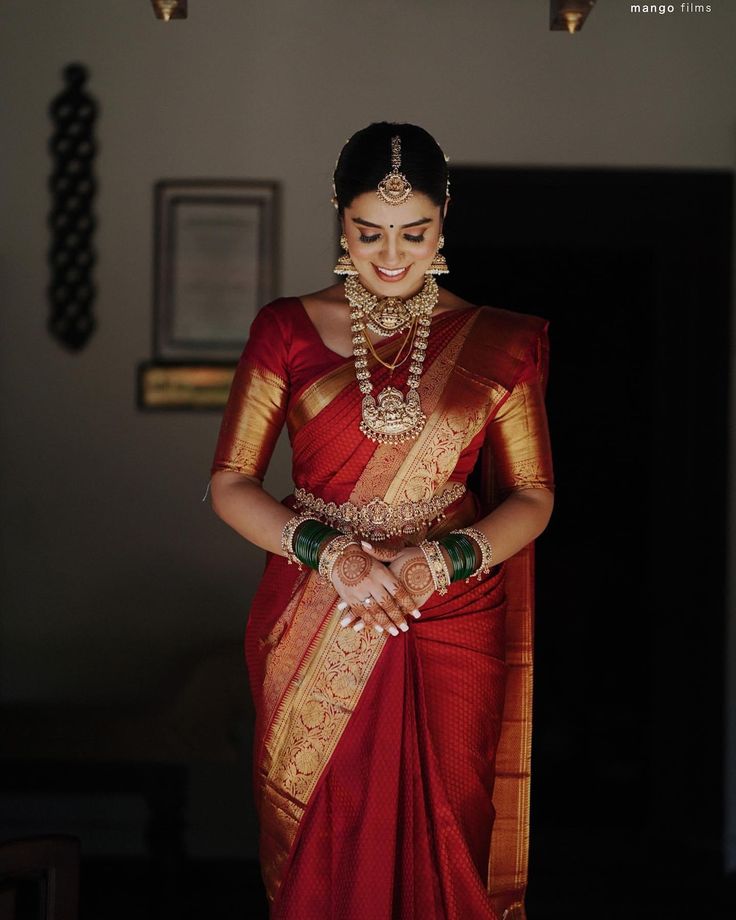 a woman in a red and gold sari