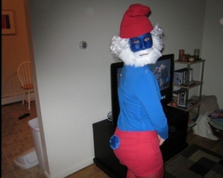 a person in a blue and red costume standing up with his hands on his hips