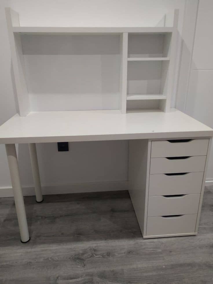 a white desk with drawers and shelves on the top, in front of a wall