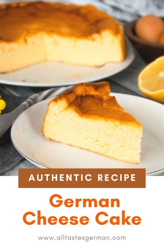 a slice of german cheese cake on a white plate with oranges in the background