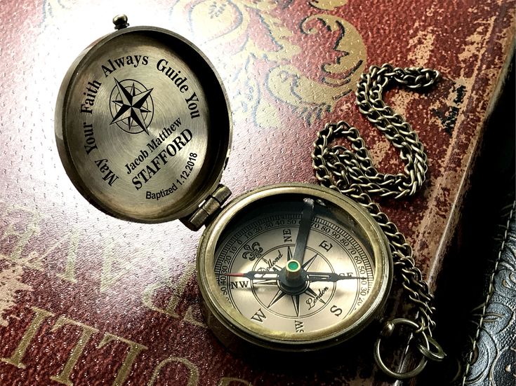 a compass and chain on top of a book