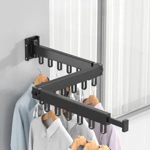 a rack with clothes hanging on it next to a window