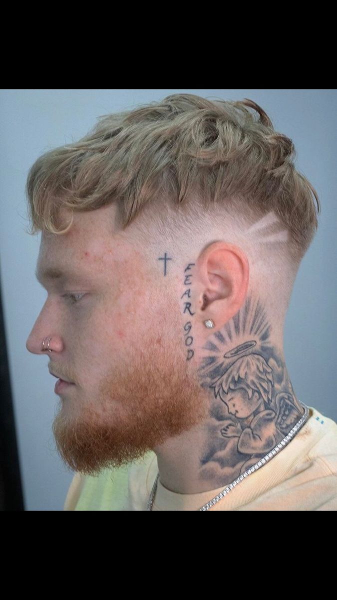 a man with a cross tattoo on his neck and behind the ear is a young boy