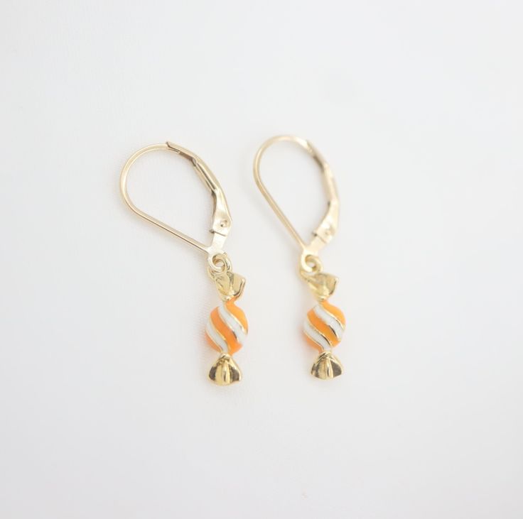 🎉Tiny enamel candy dangle earrings. 🎉Design and handcraft in our Burlington Studio ------------------------------------------------------------- PRODUCTS DETAILS Length: 29mm Width: 5mm Lever back: 14K gold filled Candy drop: 14K gold plated enamel ------------------------------------------------------------- SAME COLLECTION Necklace https://www.etsy.com/ca/listing/771460195/tiny-enamel-candy-necklace-14k-gold?click_key=b044d590c58e79aa95964c877bc70f9e68f174fc%3A771460195&click_sum=5f3b091c&ref=shop_home_active_28&sts=1 ------------------------------------------------------------- MATERIALS INTRODUCTION:  GOLD FILLED FINDINGS Gold filled is an actual layer of 5% pure gold by weight pressure bonded to another metal. Gold filled is not to be confused with gold plating as filled literally h Yellow Gold Enamel Dangle Earrings, Nickel-free Yellow Gold Enamel Earrings, Cadmium-free 14k Gold Earrings As Gift, Yellow Gold Enamel Earrings As Gift, Yellow Gold Enamel Dangle Jewelry, White Enamel Jewelry For Party, Gold Dangle Earrings For Birthday, Sweet White Earrings For Birthday, Orange Enamel Earrings As A Gift