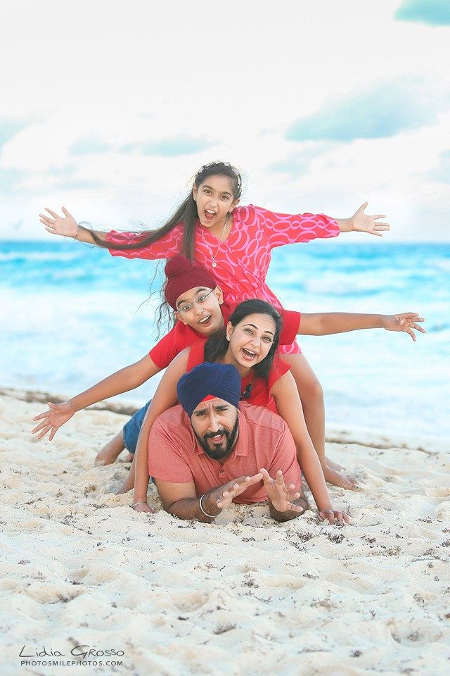 a family poses for a photo on the beach