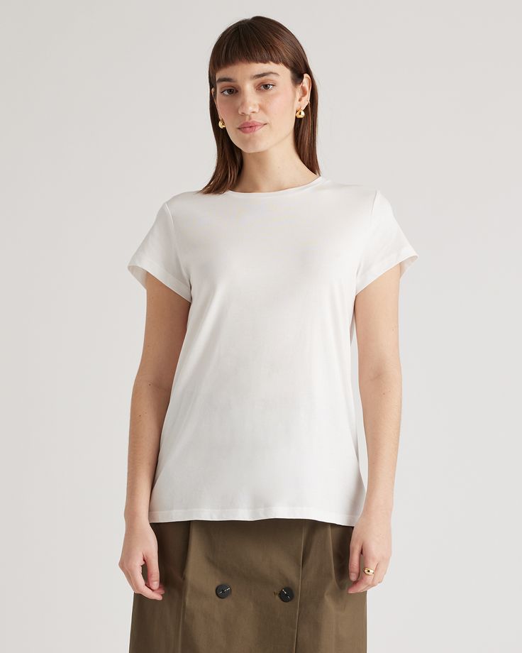 A wardrobe basic that feels anything but. Our Cotton Modal Crewneck Swing Tee is made with a super soft and stretchy cotton blend that's wrinkle-resistant with a seriously smooth finish.  | Quince | Women's Cotton Modal Crew Neck Swing Tee in White, Size Medium, Cotton/Modal Classic Stretch T-shirt For Workwear, Versatile T-shirt With Shirttail Hem, Basic Solid Stretch T-shirt, Spring Plain Stretch T-shirt, Versatile White Cotton T-shirt, Essential Summer Crew Neck Top, Classic Solid Color Everyday Top, Classic Spring Tops With Minimal Stretch, Fitted Everyday T-shirt