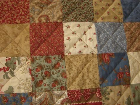 an old quilt with many different colors and patterns