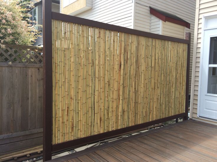 a wooden fence is next to a house