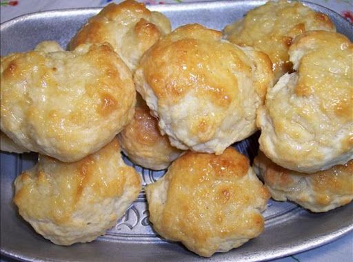 a metal plate filled with biscuits on top of a table