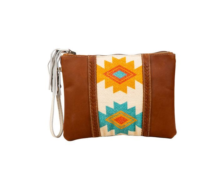 A delightful Southwest- and tribal-inspired design, in gorgeous colors, is the showpiece of this stunning bag. Tones of golden yellow, red and turquoise fill the upcycled woven rug, while panels of aged leather in warm cognac brown feature cross-stitched accents. Simply beautiful. The back is woven canvas in matching cognac brown. Zipper-close top with white leather wristlet carrying strap. Needlework Ideas, Tyler Candle Company, Purse Sewing, Western Crafts, Red And Turquoise, Concealed Carry Purse, Bags Game, Leather Rug, Small Pouch