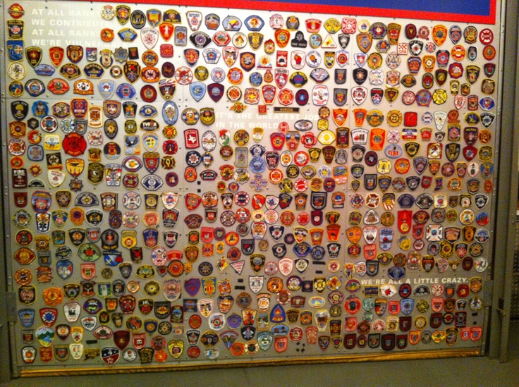 there is a large display of badges on the wall