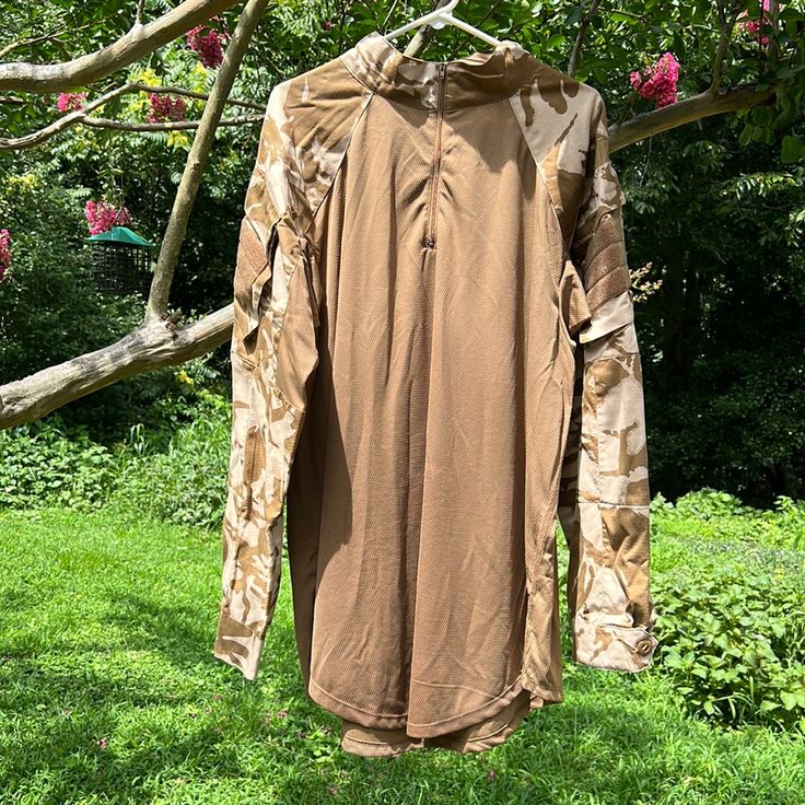 a shirt hanging on a clothes line in the grass