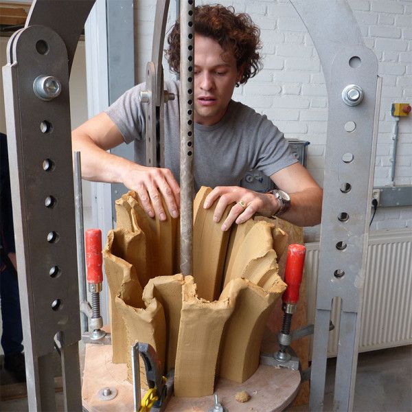 a man working on a sculpture in a factory