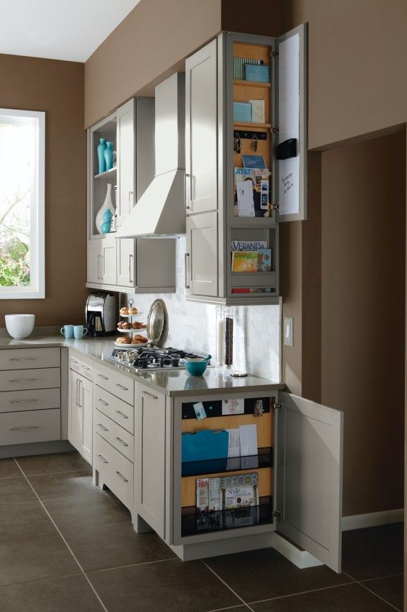 a kitchen with white cabinets and brown walls