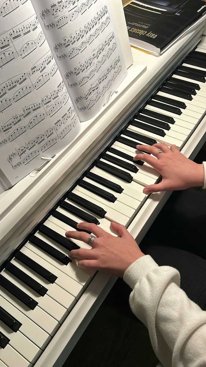 two hands on the keys of a piano