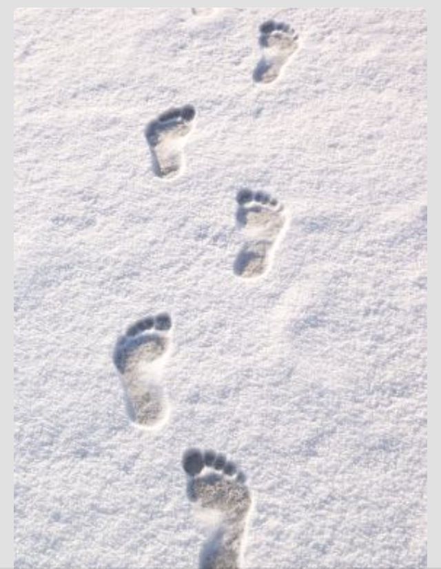 the footprints of two people are in the snow, and there is no image on this page