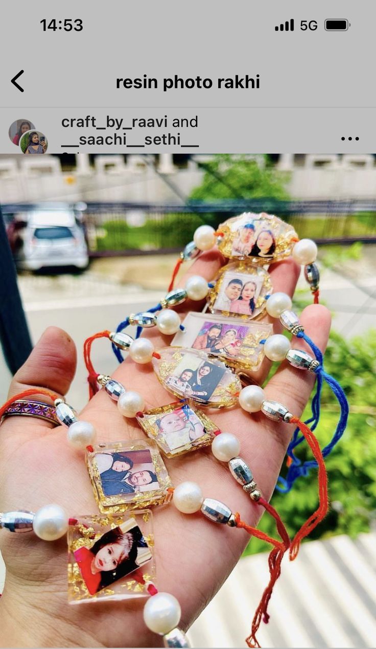 someone is holding out their hand with some pictures on it and pearls attached to the wrist