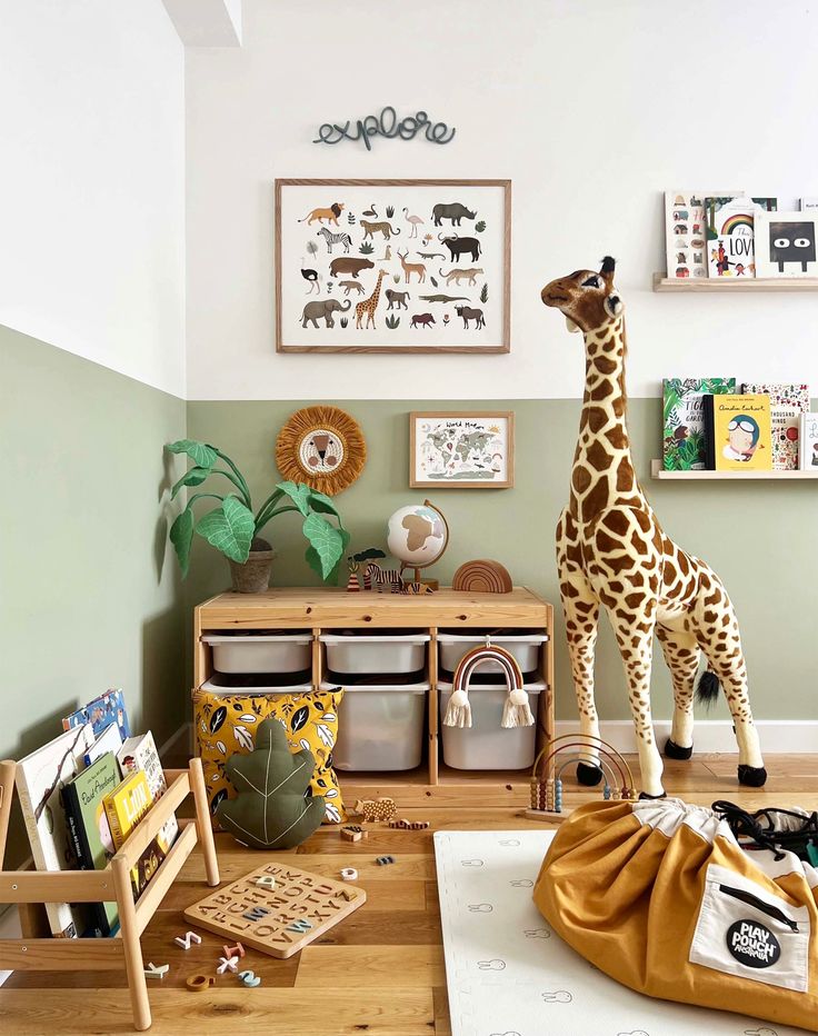 a stuffed giraffe standing on top of a wooden floor next to a chair